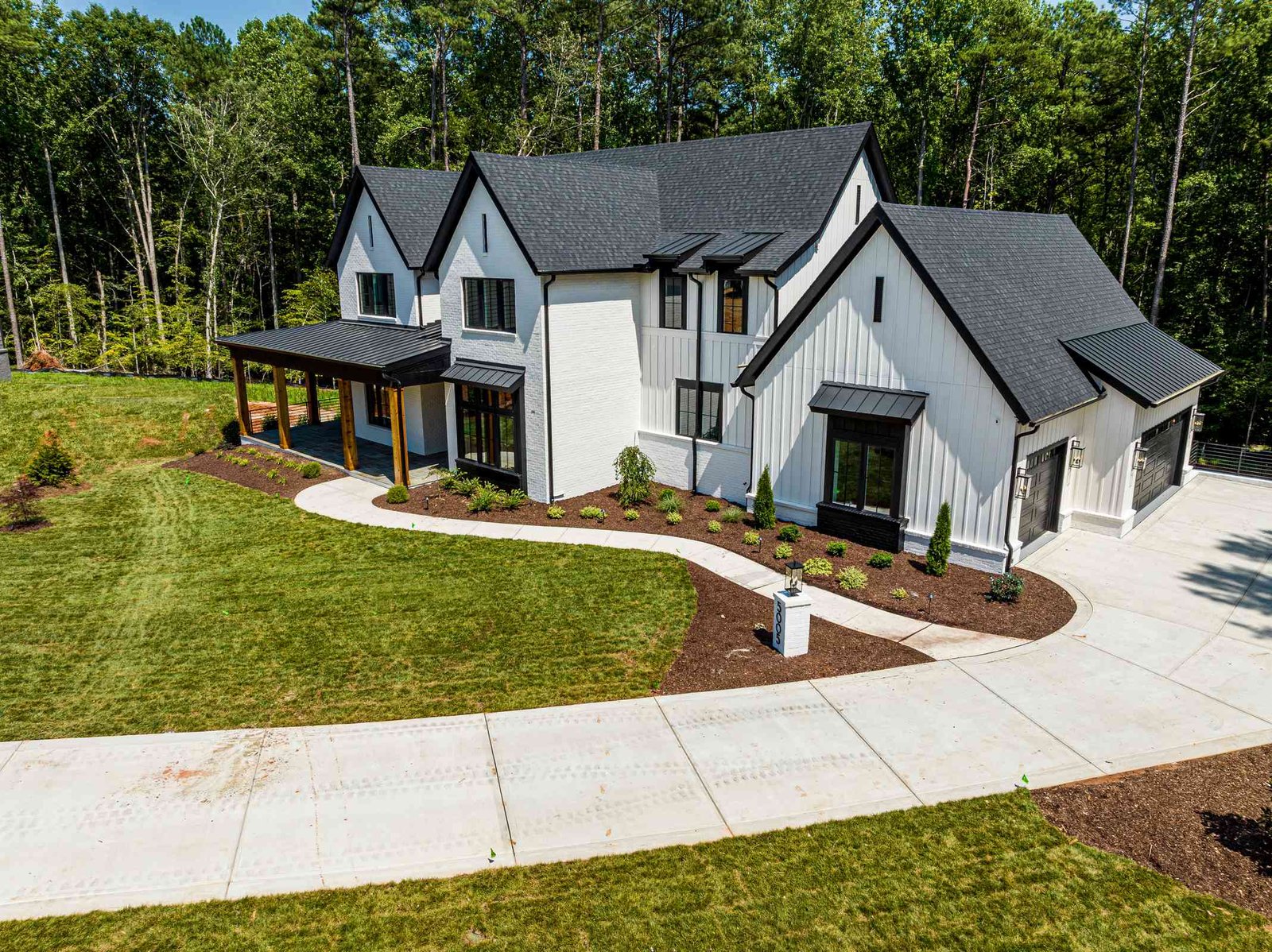 Drone view of a luxury home and approach by Shail Construction in Raleigh NC