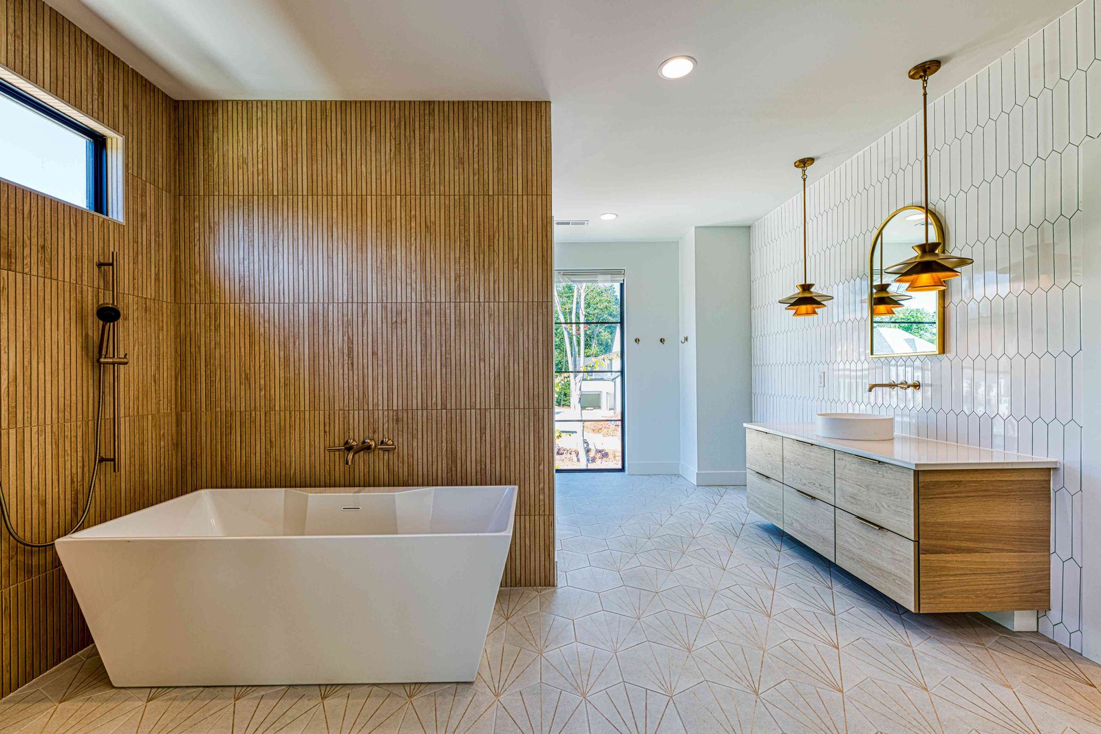 Primary bath double vanity with brass fixtures by Shail Construction in Raleigh NC