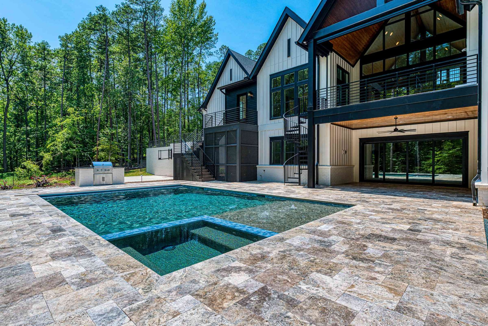 Stone rear exterior with terrace by Shail Construction in Raleigh NC