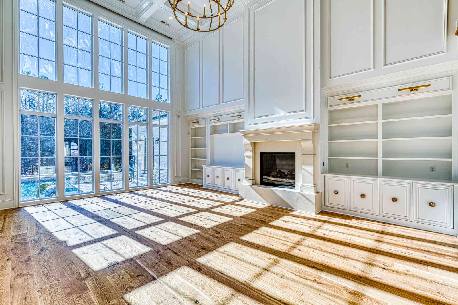 Two-story family room with stone fireplace by Shail Construction in Raleigh NC