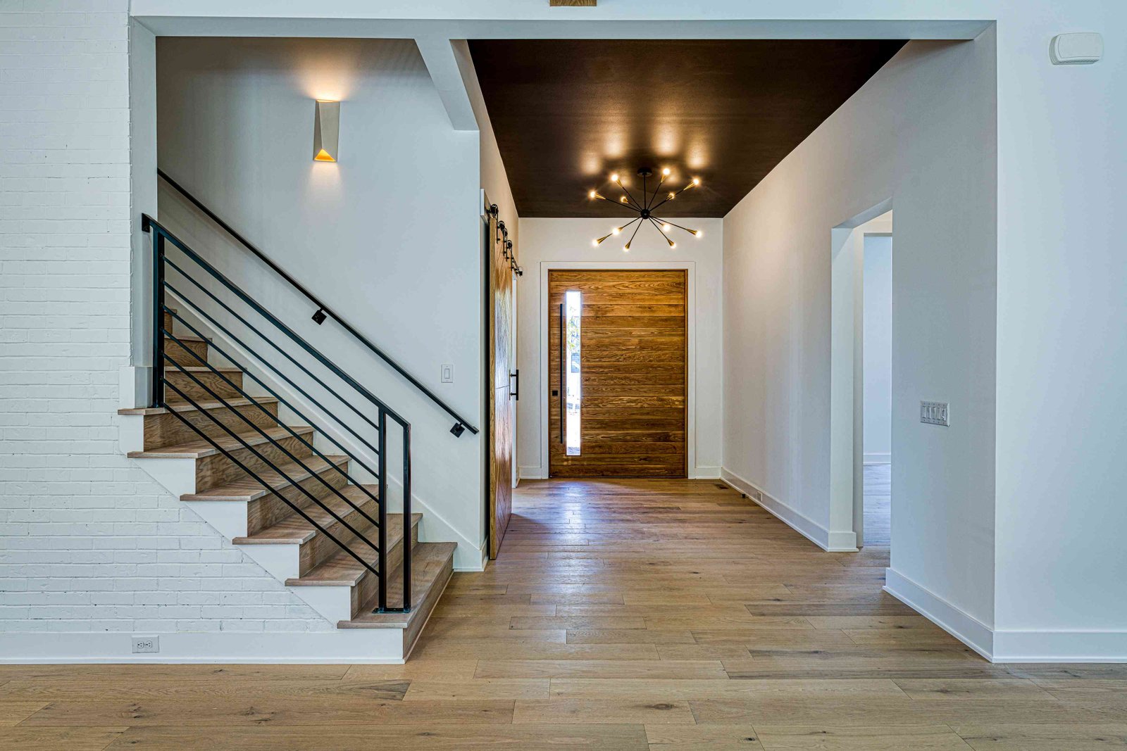 Two-story foyer with curving staircase by Shail Construction in Raleigh NC