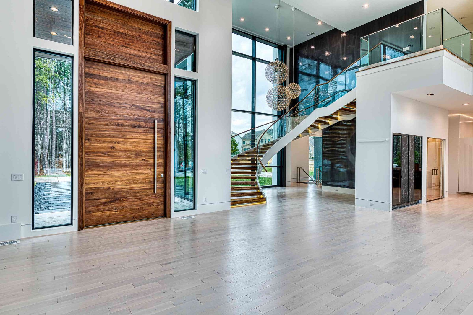 Foyer with paneled walls and chandelier by Shail Construction in Raleigh NC