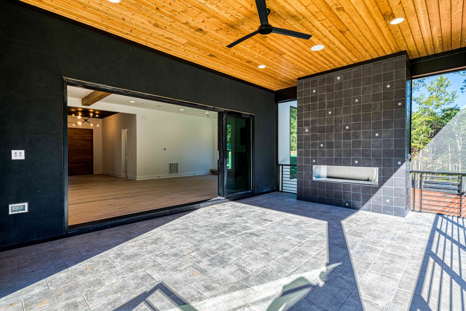 Covered terrace with steel doors open to interior by Shail Construction in Raleigh NC