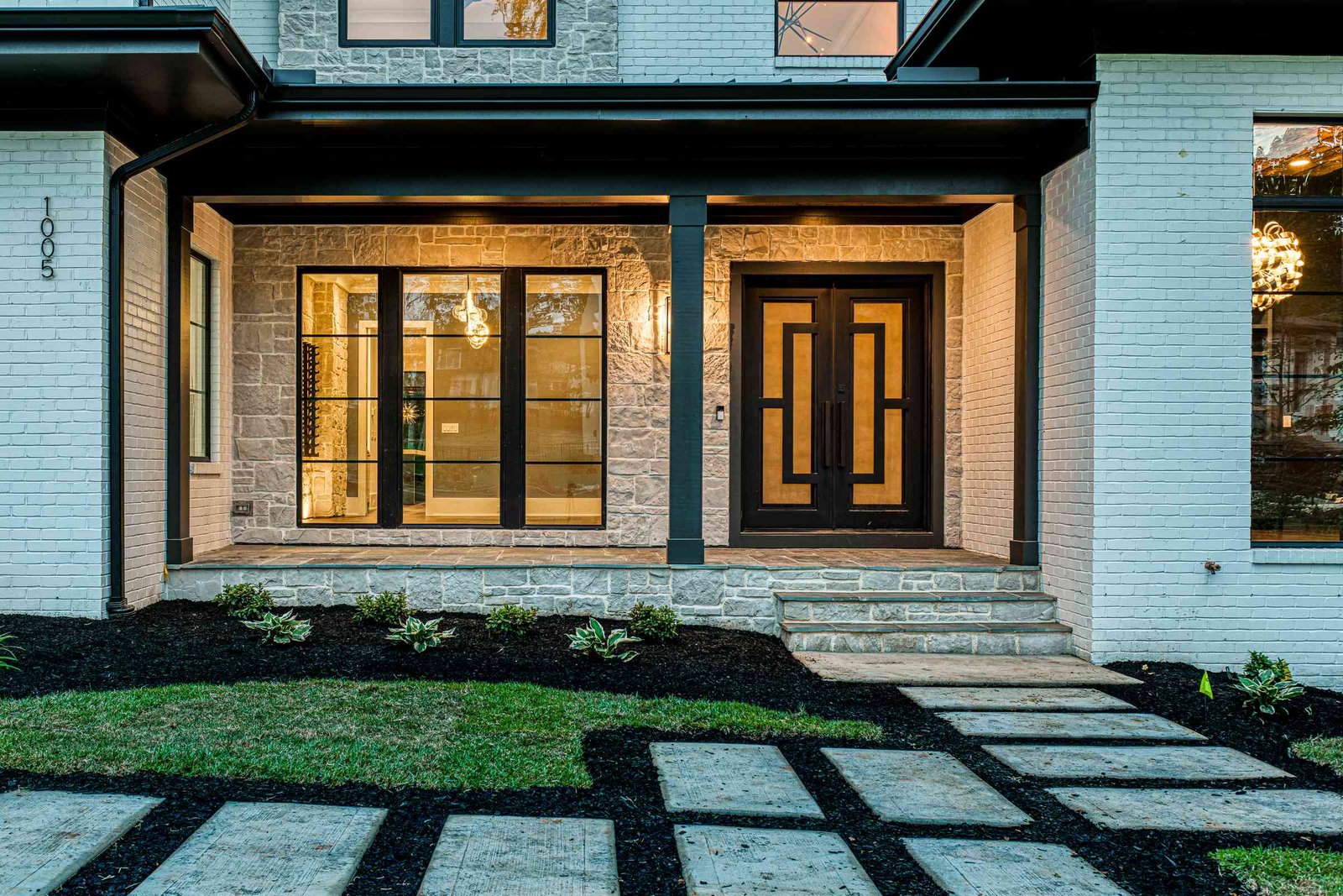 Twilight front porch with hanging lanterns by Shail Construction in Raleigh NC