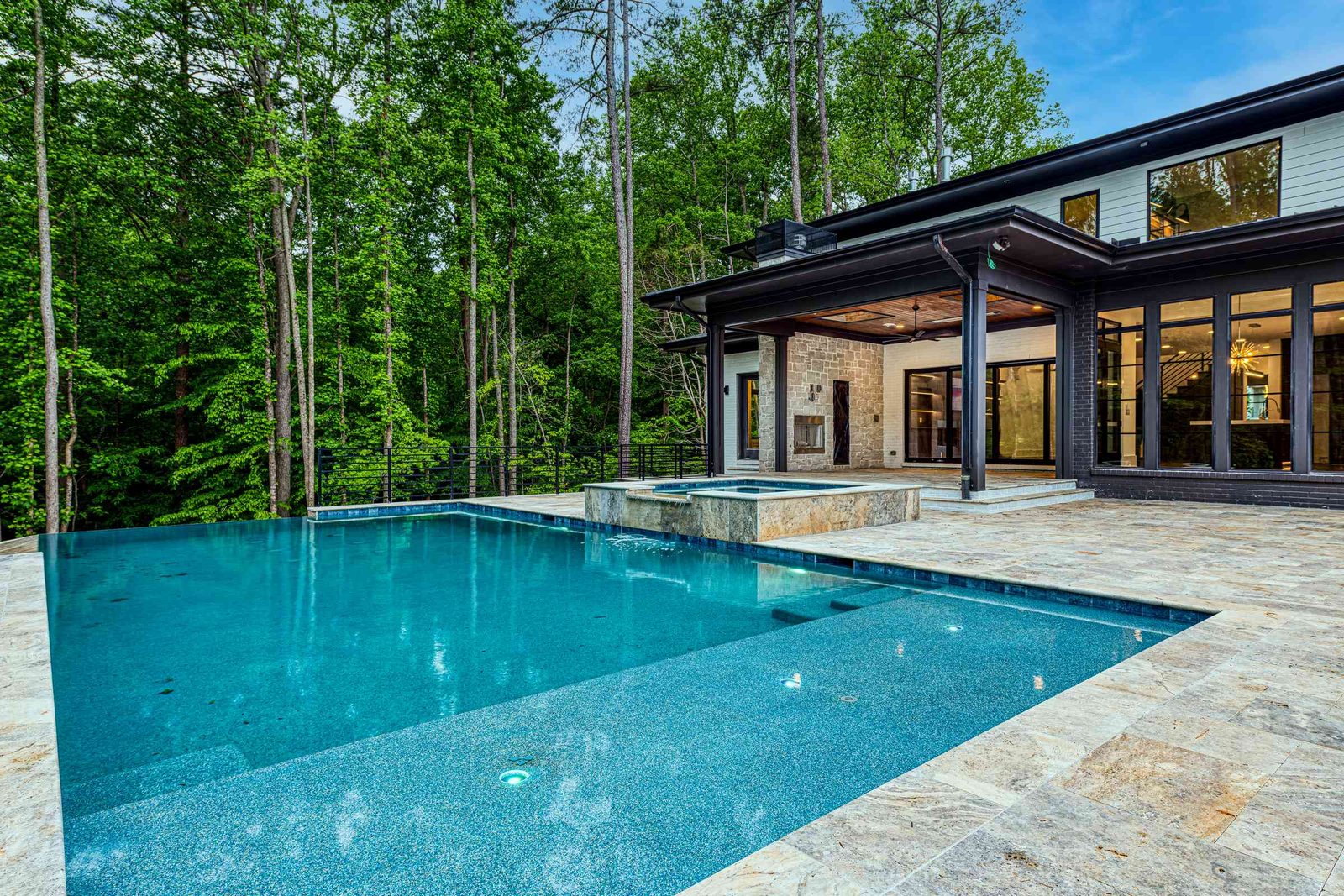 Pool deck with stone coping and lounge area by Shail Construction in Raleigh NC