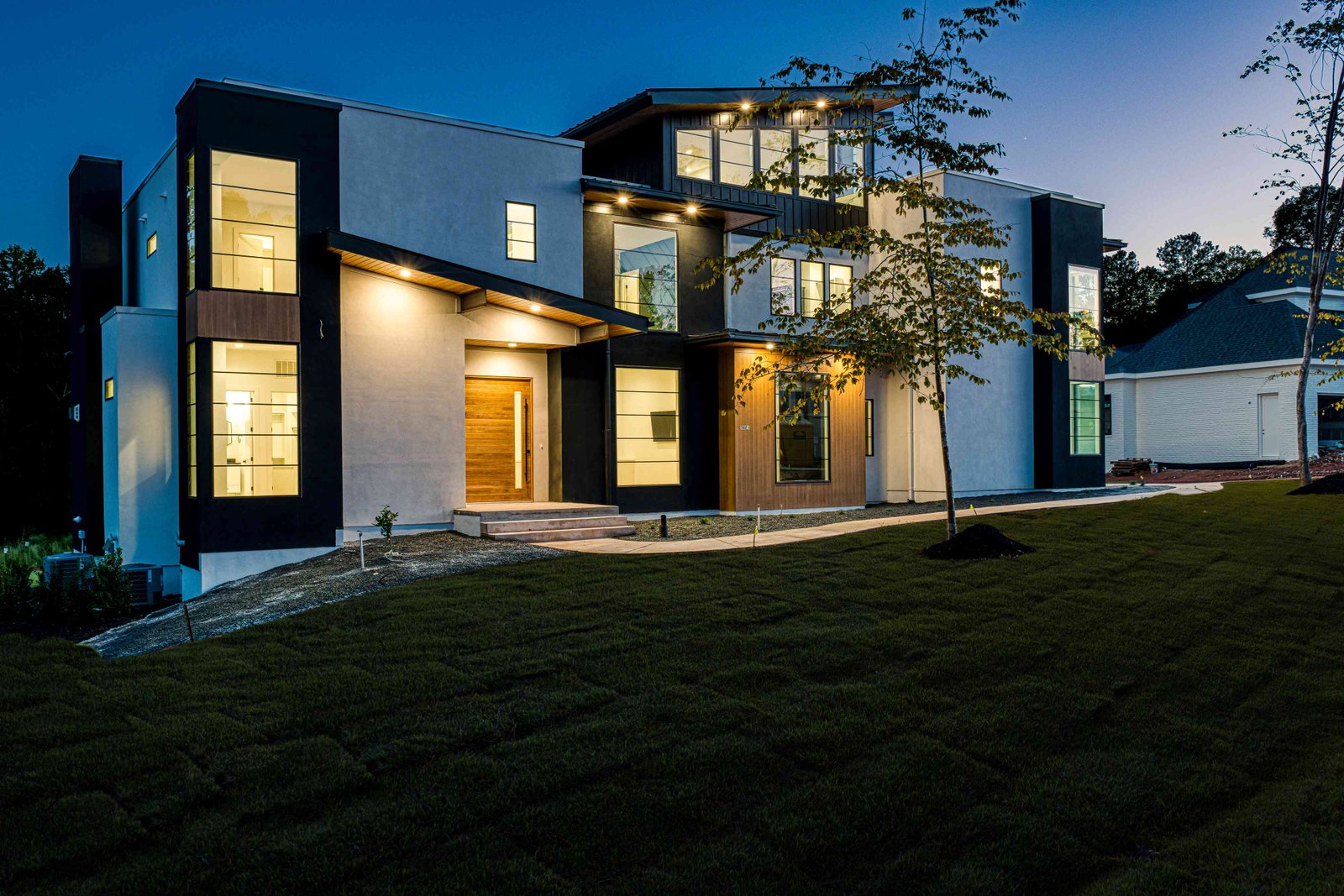 Twilight front elevation with landscape lighting by Shail Construction in Raleigh NC