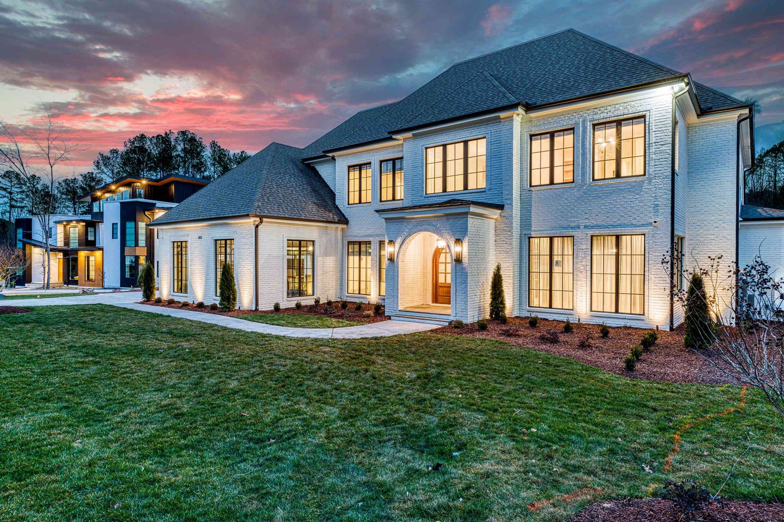 Twilight front view of a brick estate by Shail Construction in Raleigh NC